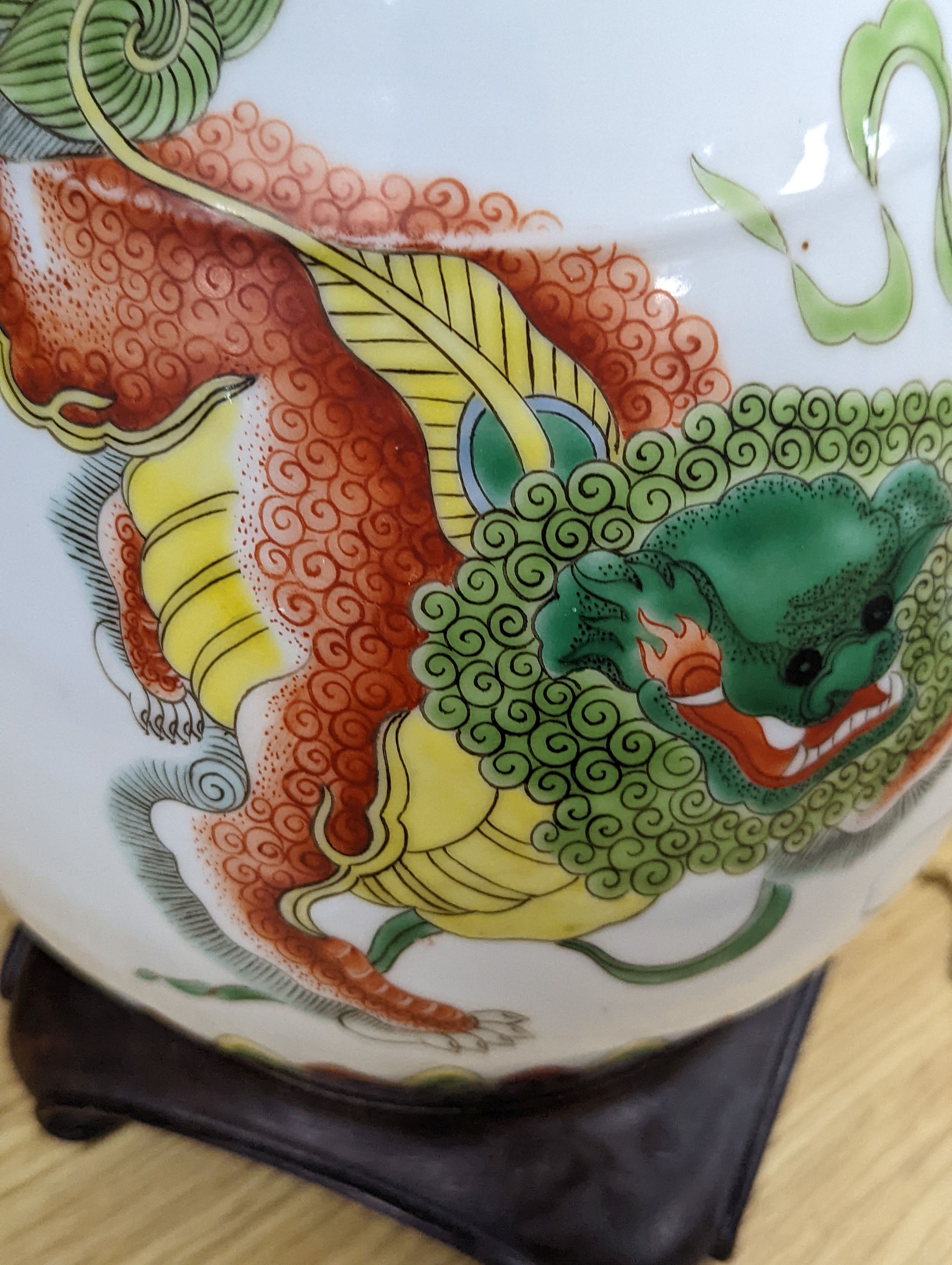 A Chinese famille verte pear-shaped ‘Buddhist lion’ vase, on stand, 32 cms high not including stand